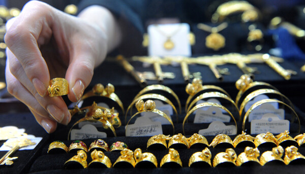 Gold rings and gold bracelets are displayed in a jewelry shop in downtown Seoul.