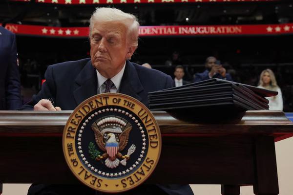 U.S. President Donald Trump signs the third executive order during the inaugural parade inside Capital One Arena on the inauguration day of his second presidential term, in Washington, U.S. January 20, 2025. (REUTERS)