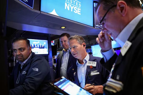 Traders work on the floor at the New York Stock Exchange (NYSE) in New York City