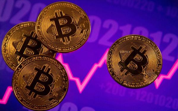 A representation of virtual currency Bitcoin is seen in front of a stock graph in this illustration. REUTERS